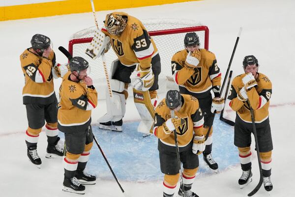 Vegas Golden Knights players react after losing to the Edmonton Oilers in overtime of Game 5 of a second-round NHL hockey playoff series Wednesday, May 14, 2025, in Las Vegas. (AP Photo/John Locher)