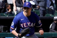 Texas Rangers pitcher Robert Garcia (62) celebrates after getting the final out against the...