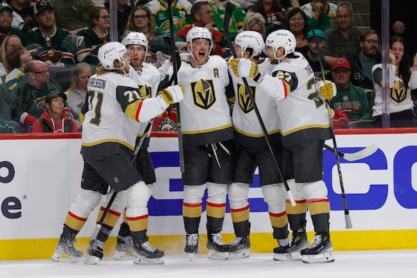 Vegas Golden Knights center Jack Eichel, center, celebrates with teammates after scoring during the second period of Game 6 of a first-round NHL hockey playoff series against the Minnesota Wild, Thursday, May 1, 2025, in St. Paul, Minn. (AP Photo/Bailey Hillesheim)