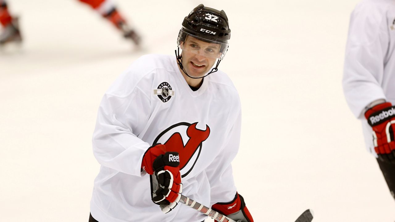 New Jersey Devils' Mathieu Darche attends the team's first official practice since the NHL hockey lockout ended, Sunday, Jan. 13, 2013, in Newark, N.J. (AP Photo/Julio Cortez, file)