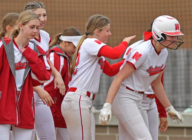 Naperville Central's Shea Meech gets a pat on the back from teammate Avery Hayward 