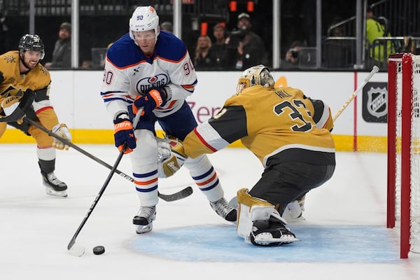 Edmonton Oilers right wing Corey Perry (90) scores against Vegas Golden Knights goaltender Adin Hill (33) during the first period of Game 1 of a second-round NHL hockey playoff series Tuesday, May 6, 2025, in Las Vegas. (AP Photo/John Locher)