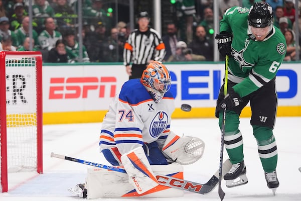 Edmonton Oilers goaltender Stuart Skinner (74) defends the goal against Dallas Stars center Mikael Granlund (64) during the first period in Game 2 of the Western Conference finals in the NHL hockey Stanley Cup playoffs Friday, May 23, 2025, in Dallas. (AP Photo/LM Otero)
