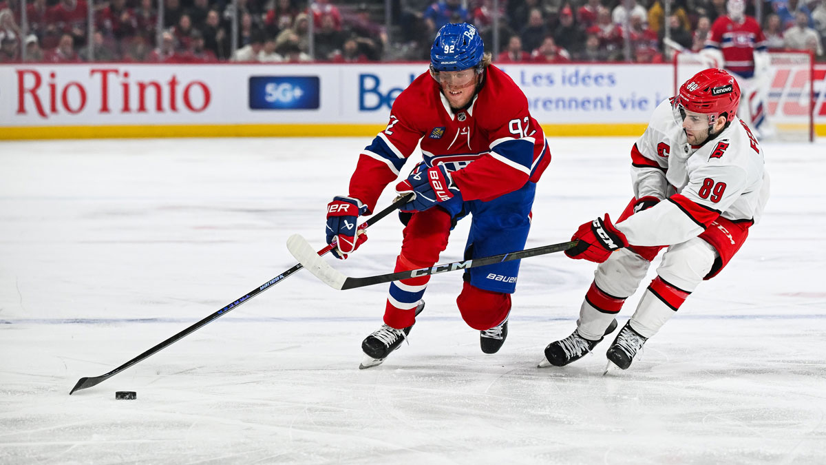 Montreal Canadiens right wing Patrik Laine (92) plays the puck against Carolina Hurricanes defenseman Domenick Fensore (89) in the first period at Bell Centre. 