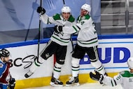 Joel Kiviranta #25 of the Dallas Stars is congratulated by his teammates after scoring a...