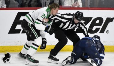 Linesman Devin Berg (87) gets between Dallas Stars' Roope Hintz (24) and Winnipeg Jets' Dylan Demelo (2) during the third period of an NHL hockey playoff series in Winnipeg, Manitoba, Wednesday, May 7, 2025. (Fred Greenslade/The Canadian Press via AP)
