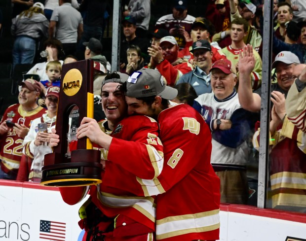 Denver Pioneers defenseman Shai Buium (8) hugs defenseman Zeev Buium (28) after defeating the Boston College Eagles 2-0 winning the 2024 NCAA Frozen Four championship game at the Xcel Energy Center in St. Paul, Minnesota on Saturday, April 13, 2024. (Photo by Andy Cross/The Denver Post)