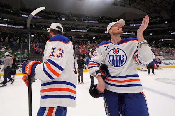 Edmonton Oilers center Mattias Janmark (13) and defenseman John Klingberg (36) celebrate after winning Game 5 of the Western Conference finals against the Dallas Stars in the NHL hockey Stanley Cup playoffs, Thursday, May 29, 2025, in Dallas. (AP Photo/Julio Cortez)