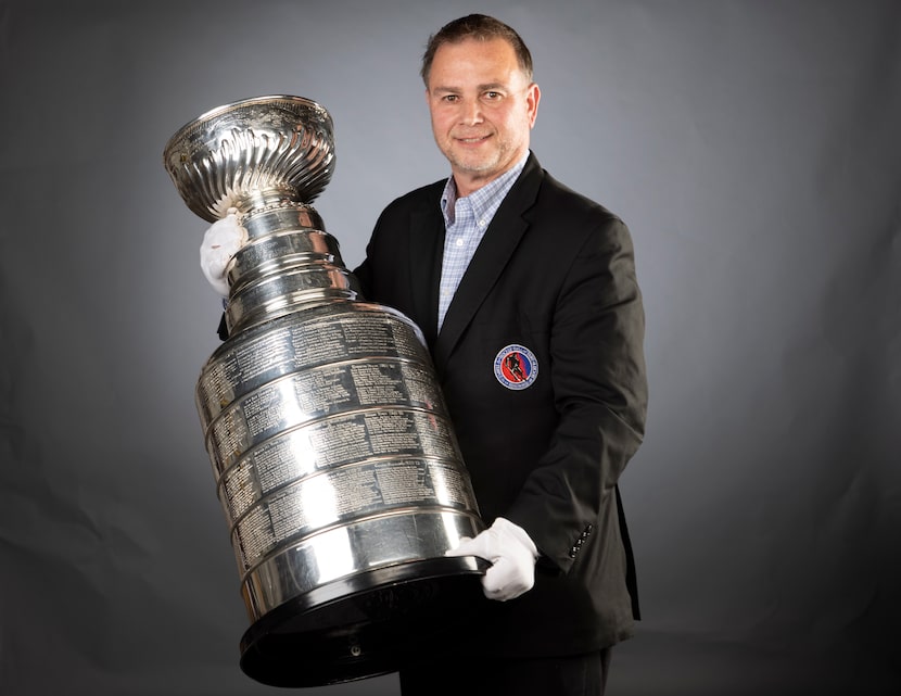Howie Borrow, keeper of the Stanley Cup, poses for a photo with the trophy at the Dallas...