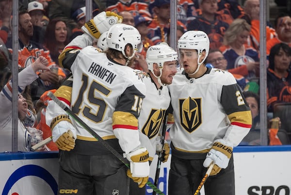 Vegas Golden Knights' Noah Hanifin (15), Reilly Smith (19) and Zach Whitecloud (2) celebrate after a goal against the Edmonton Oilers during the first period of Game 3 of a second-round NHL hockey playoff series in Edmonton, Alberta, Saturday, May 10, 2025. (Jason Franson/The Canadian Press via AP)