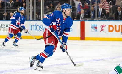 New York Rangers forward Alexis Lafreniere skates in 2025 game.