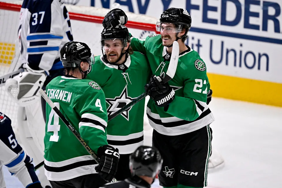 Dallas Stars center Sam Steel (18) and left wing Mason Marchment (27) and defenseman Miro Heiskanen (4) celebrates a goal scored by Steel against the Winnipeg Jets during the second period in game six of the second round of the 2025 Stanley Cup Playoffs at American Airlines Center. Mandatory Credit: Jerome Miron-Imagn Images