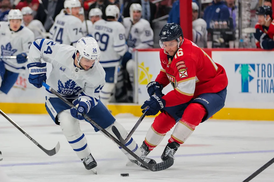 Apr 8, 2025; Sunrise, Florida, USA; Toronto Maple Leafs left wing Scott Laughton (24) and Florida Panthers center Aleksander Barkov (16) battle for the puck during the third period at Amerant Bank Arena. Mandatory Credit: Sam Navarro-Imagn Images