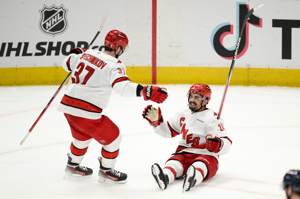 Carolina's Andrei Svechnikov and Seth Jarvis celebrate a goal in Game 5 against the Capitals.
