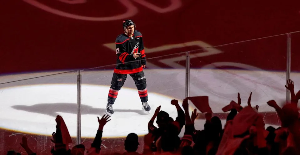 Carolina Hurricanes center Logan Stankoven (22) offers fans a puck as he is recognized for scoring two goals following the HurricanesÕ 4-1 victory over the New Jersey Devils on Sunday, April 20, 2025 at Lenovo Center in Raleigh, N.C.