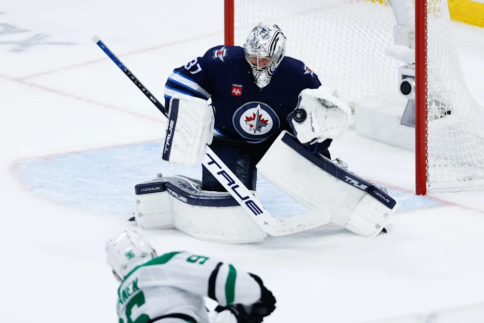 Winnipeg Jets goalie Connor Hellebuyck (37) makes a save on a shot by Dallas Stars forward Mikko Rantanen (96) during the third period in game five of the second round of the 2025 Stanley Cup Playoffs.Terrence Lee-Imagn Images