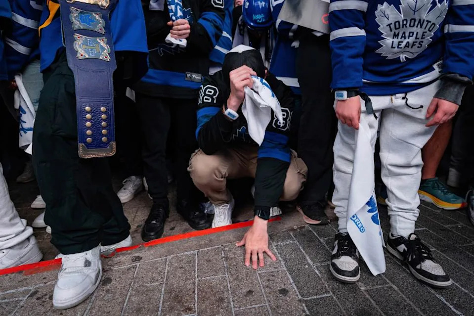 Heartbroken fans watch on as the Maple Leafs rollover in a Game 7 blowout. AP