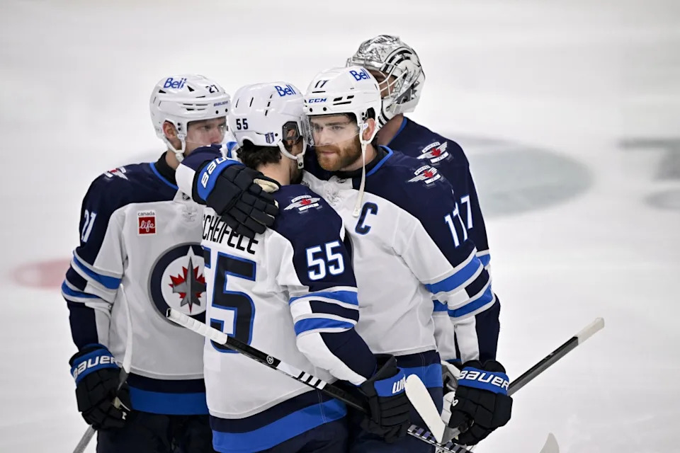 Winnipeg Jets center Adam Lowry (17) hugs center Mark Scheifele (55) after the Jets lose to the Dallas Stars during the overtime period in game six of the second round of the 2025 Stanley Cup Playoffs.Jerome Miron-Imagn Images