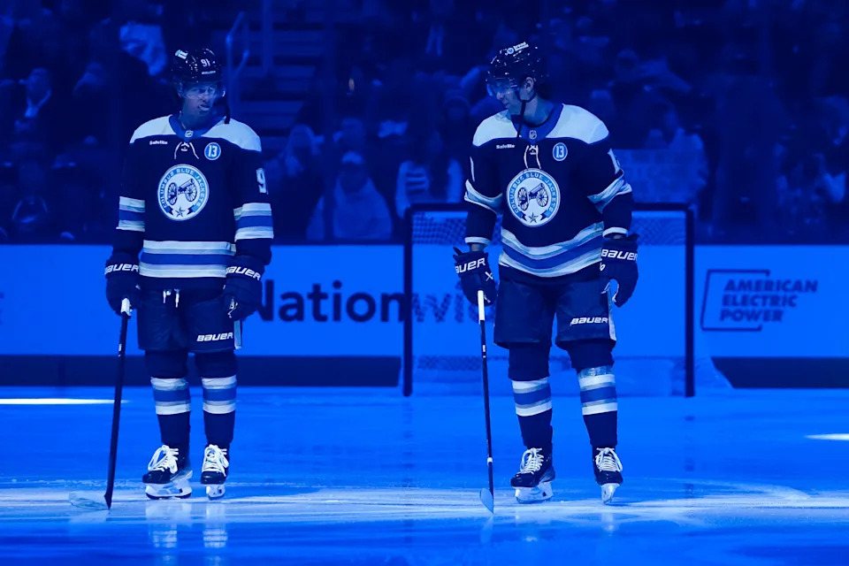 Blue Jackets forwards Kent Johnson (left) and Adam Fantilli await the start of a Dec. 19 game against the Devils.