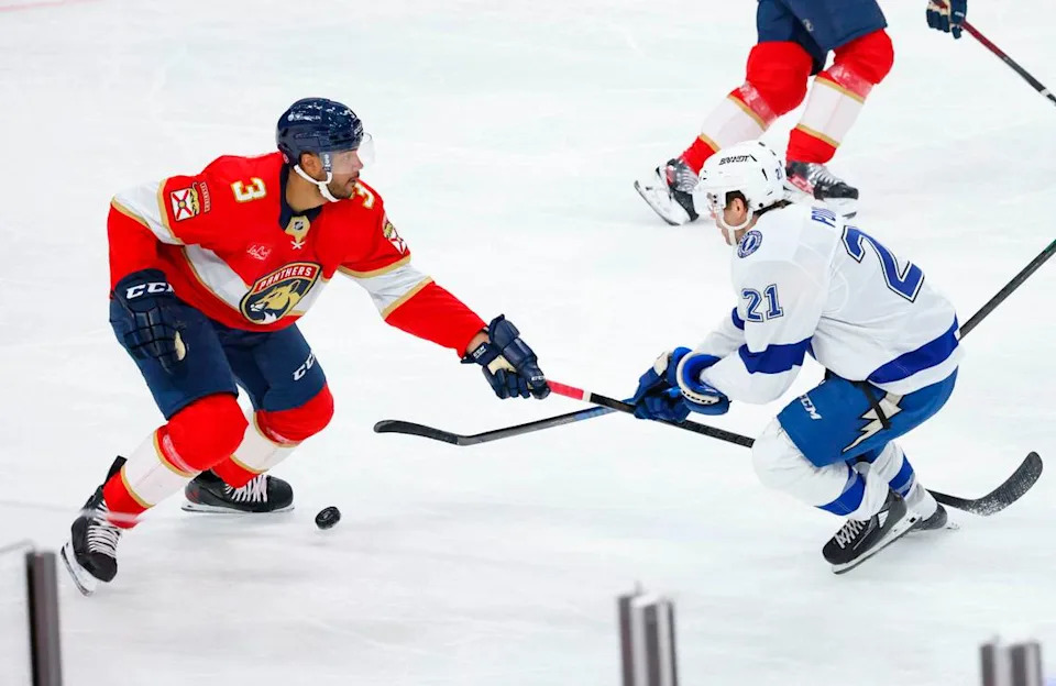 Florida Panthers defenseman Seth Jones (3) tries to get the puck from Tampa Bay Lightning center Brayden Point (21) during the second period of a game on Monday, March 3, 2025, at Amerant Bank Arena in Sunrise, Fla.