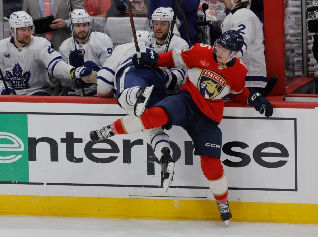 Florida Panthers center Anton Lundell (15) knocks Toronto Maple Leafs...