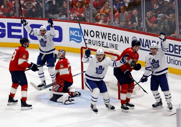 Toronto Maple Leafs players celebrate the goal that tied the...