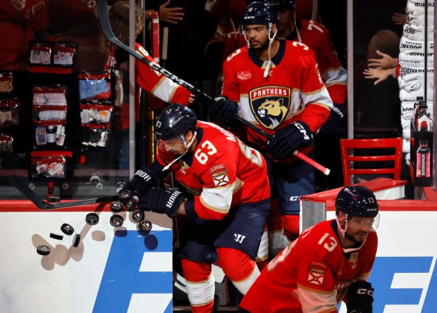 Florida Panthers center Brad Marchand (63) knocks pucks off the...