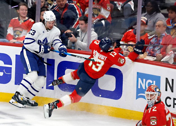 Florida Panthers center Sam Reinhart (13) is pounded by Toronto...