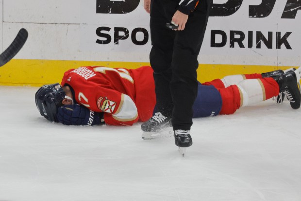 Florida Panthers center Evan Rodrigues (17) lies on the ice...