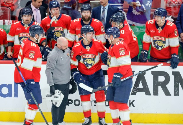 Florida Panthers center Evan Rodrigues (17) is helped off the...