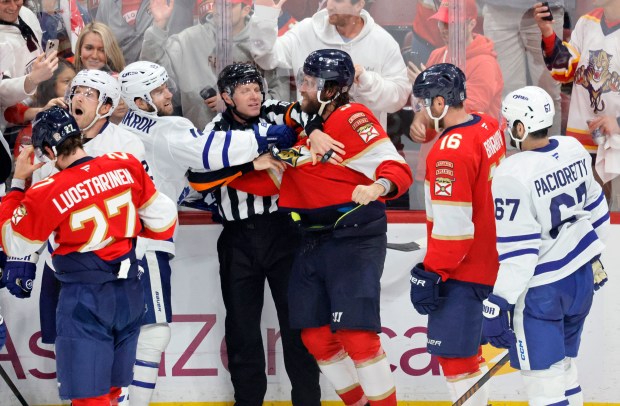 Officials separate Florida Panthers and Toronto Maple Leafs players in...