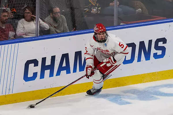 Tom Willander #5 of the Boston University Terriers competes for a puck