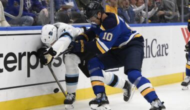 Nov 7, 2024; St. Louis, Missouri, USA; St. Louis Blues center Brayden Schenn (10) checks Utah Hockey Club defenseman Michael Kesselring (7) during the second  period at Enterprise Center. Mandatory Credit: Jeff Le-Imagn Images