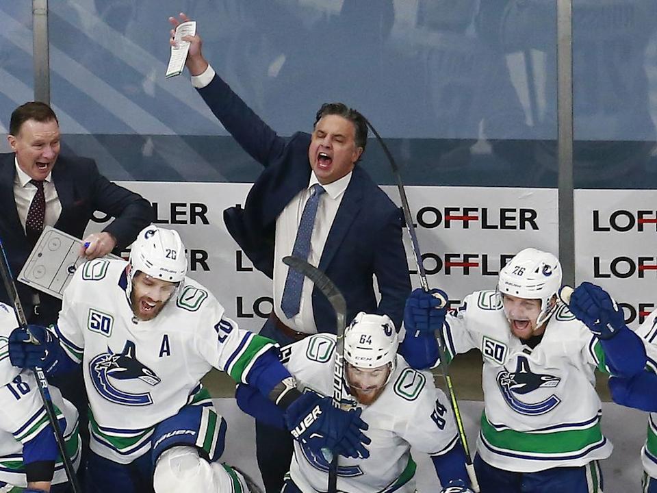  Canucks head coach Travis Green celebrates 5-4 overtime victory over the Wild on Aug. 7, 2020 during the Edmonton bubble to advance to first round of NHL playoffs.