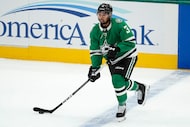 Dallas Stars defenseman Matt Dumba makes a pass for the assist as defenseman Miro Heiskanen...
