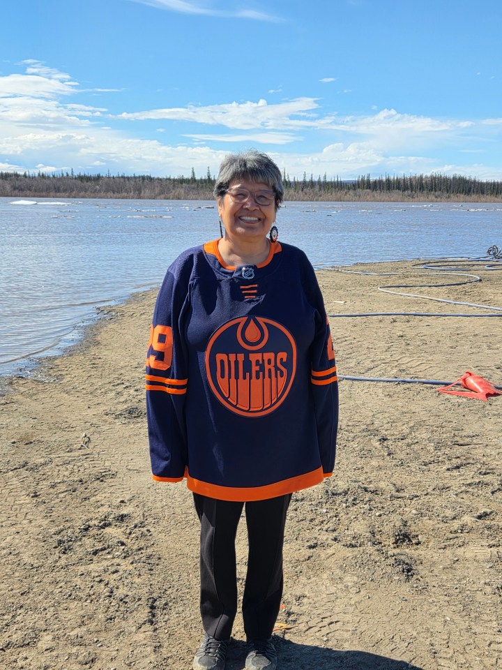 Georgina Neyando is pictured in front of the Peel River as the ice thins in late May. "Go Oilers go, bring the Stanley Cup home," she writes. Photo: Submitted