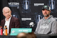 Dallas Stars general manager Jim Nill (left) and head coach Pete DeBoer listen to a question...