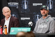 Dallas Stars general manager Jim Nill (left) and head coach Pete DeBoer listen to a question...