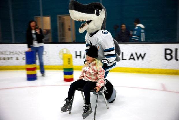 San Jose Sharks mascot SJ Sharkie pushes Ella Pallari, 7, from Livermore, as her mom Noelle watches on during the LKT1D Fund (Luke Kunin Type 1 Diabetes) Skating Party at Sharks Ice in San Jose, Calif., on Sunday, Jan. 26, 2025. (Nhat V. Meyer/Bay Area News Group)
