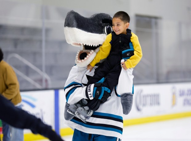Juan Cruz, 5, from San Jose, get a ride from San Jose Sharks mascot SJ Sharkie during the LKT1D Fund (Luke Kunin Type 1 Diabetes) Skating Party at Sharks Ice in San Jose, Calif., on Sunday, Jan. 26, 2025. (Nhat V. Meyer/Bay Area News Group)