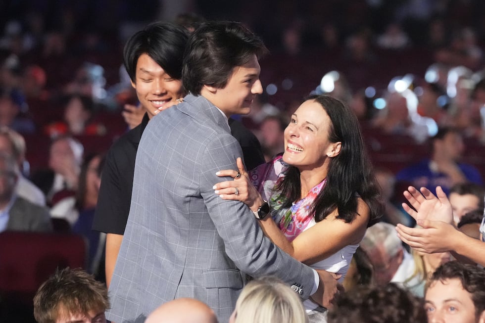 Ryker Lee, middle, is congratulated after being drafted by the Nashville Predators during the...