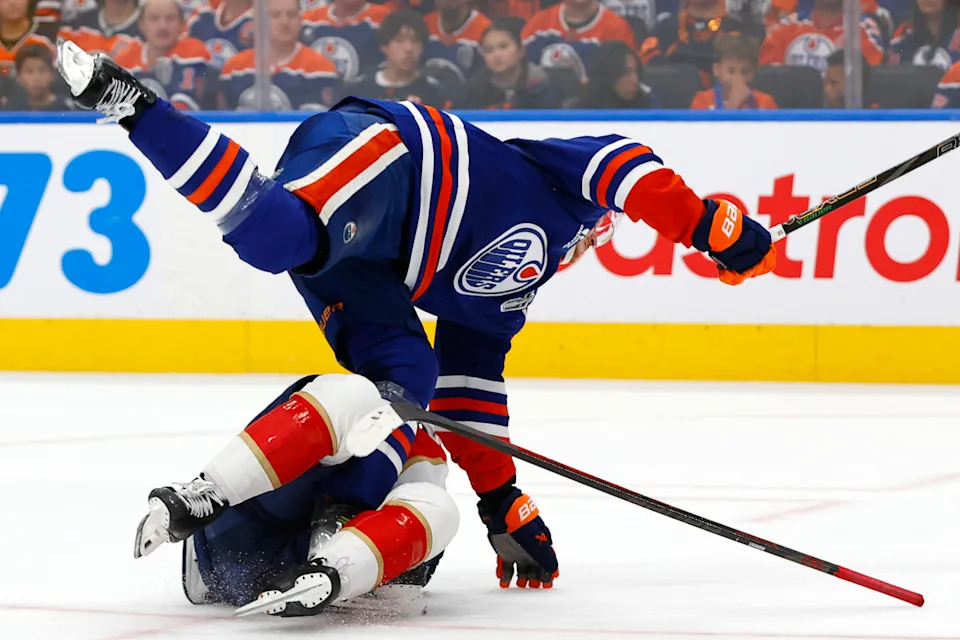 Edmonton Oilers center Trent Frederic checks Florida Panthers center Evan Rodrigues during a 2025 Stanley Cup Final game at Rogers Place.Perry Nelson-Imagn Images