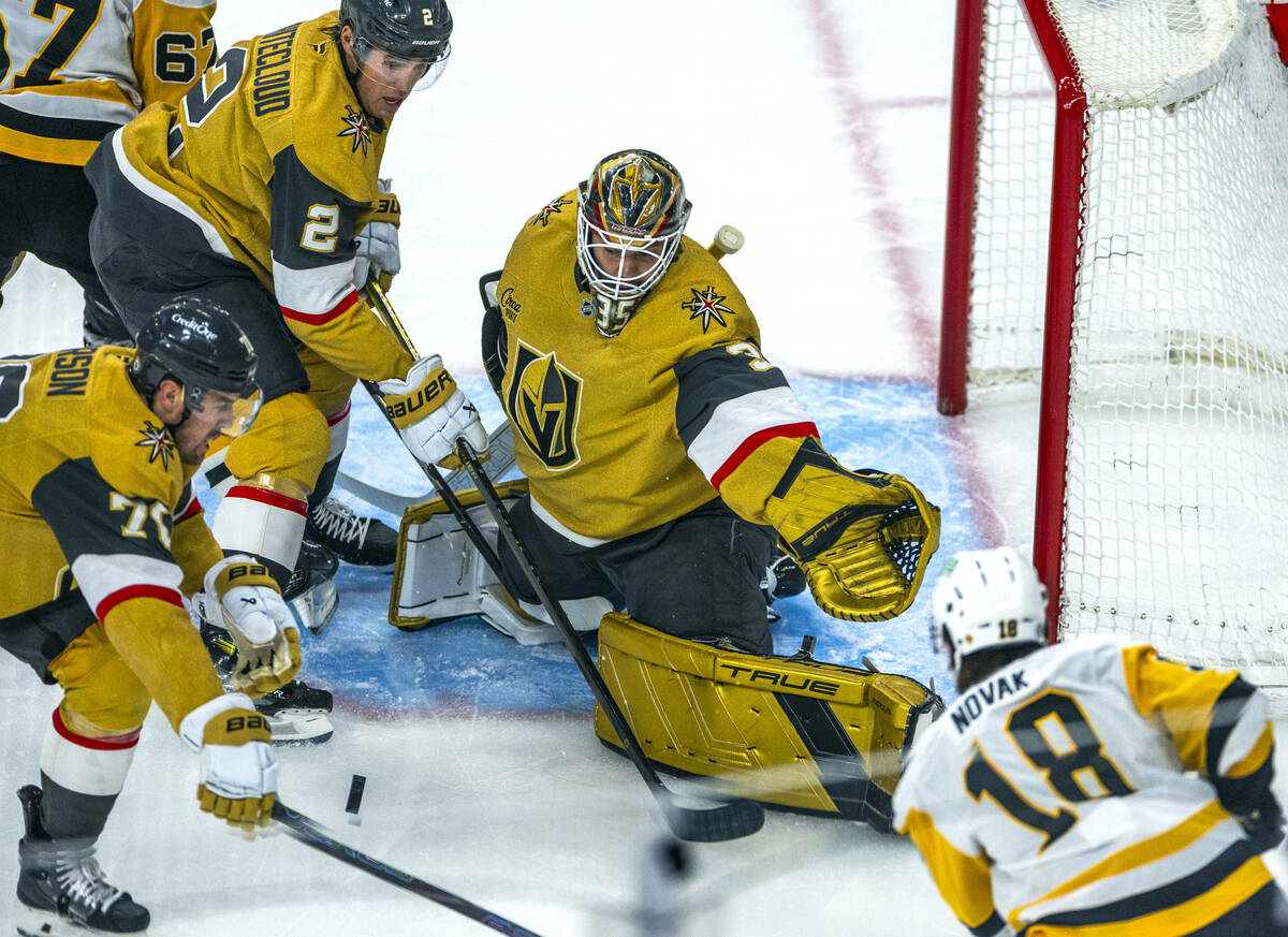 Golden Knights goaltender Ilya Samsonov (35) and teammates defend the net with a shot by Pittsb ...