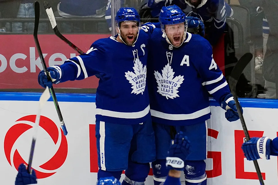 Toronto Maple Leafs defenseman Morgan Rielly (44) celebrates a goal against the Tampa Bay Lightning with forward John Tavares (91).John E&period; Sokolowski-Imagn Images