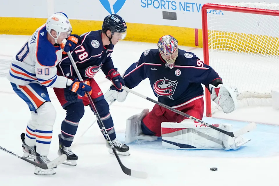 Columbus Blue Jackets goaltender Elvis Merzlikins (90) saves a shot in front of defenseman Damon Severson (78) and Edmonton Oilers right wing Corey Perry (90) during the second period of the NHL hockey game at Nationwide Arena in Columbus on Monday, Oct. 28, 2024.