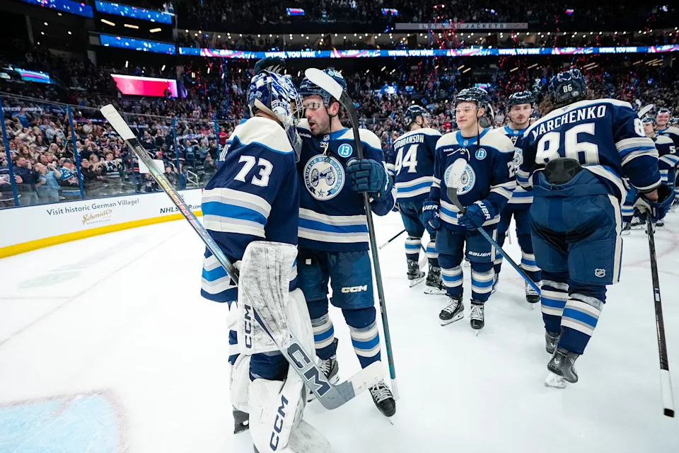 Columbus Blue Jackets defenseman Dante Fabbro (15) hugs goaltender Jet Greaves (73) following the 6-1 win over the New York Islanders in the team's final NHL hockey game of the season at Nationwide Arena in Columbus on April 17, 2025.