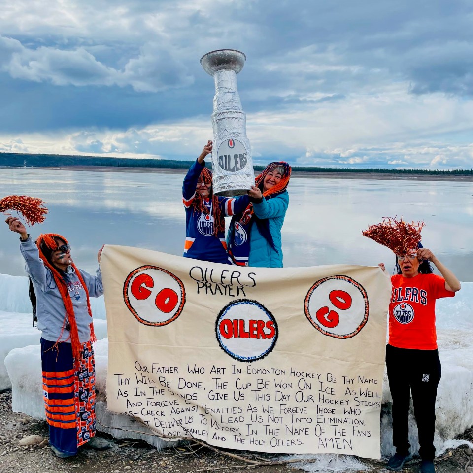 Betty Barnaby and friends in Fort Good Hope with their own Stanley Cup and "Oilers prayer" banner. Photo: Betty Barnaby