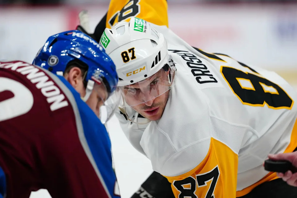 Penguins center Sidney Crosby (87) and Avalanche center Nathan MacKinnon (29) wait for the puck to drop.Ron Chenoy-Imagn Images