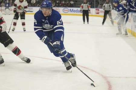 Toronto Maple Leafs forward Easton Cowan carrying the puck in the offensive zone during a pre-season game against Ottawa. Toronto Maple Leafs forward Easton Cowan carrying the puck in the offensive zone during a pre-season game against Ottawa.
