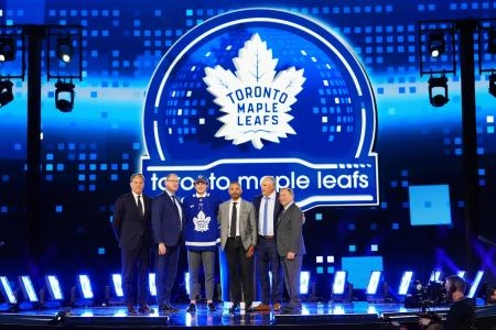Toronto Maple Leafs executives standing alongside Ben Danford after his selection in the first round. Toronto Maple Leafs executives standing alongside Ben Danford after his selection in the first round.